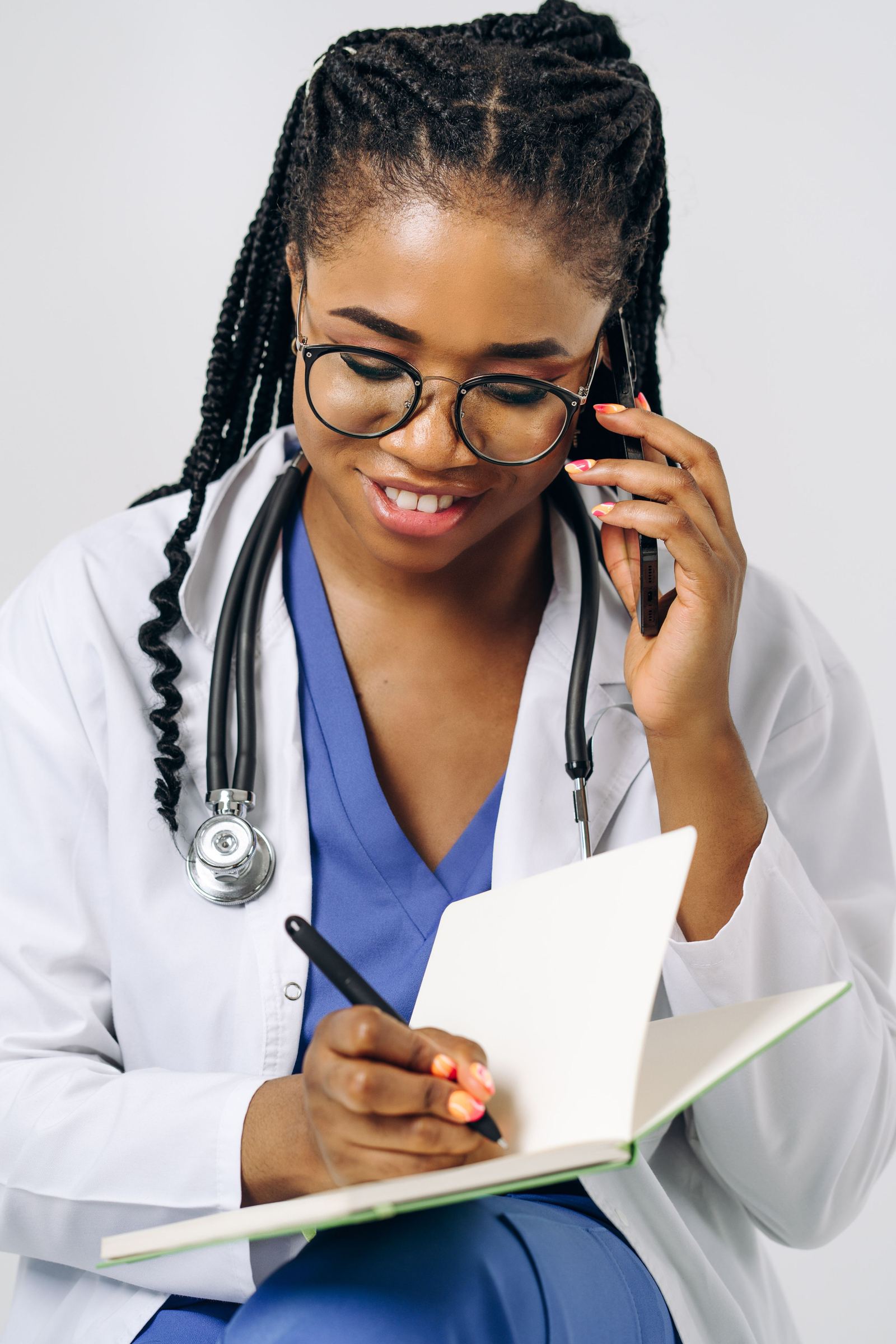 Médica anotando em bloco durante atendimento